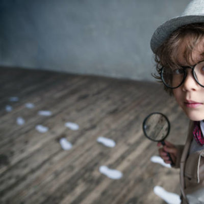 Little detective with a magnifying glass